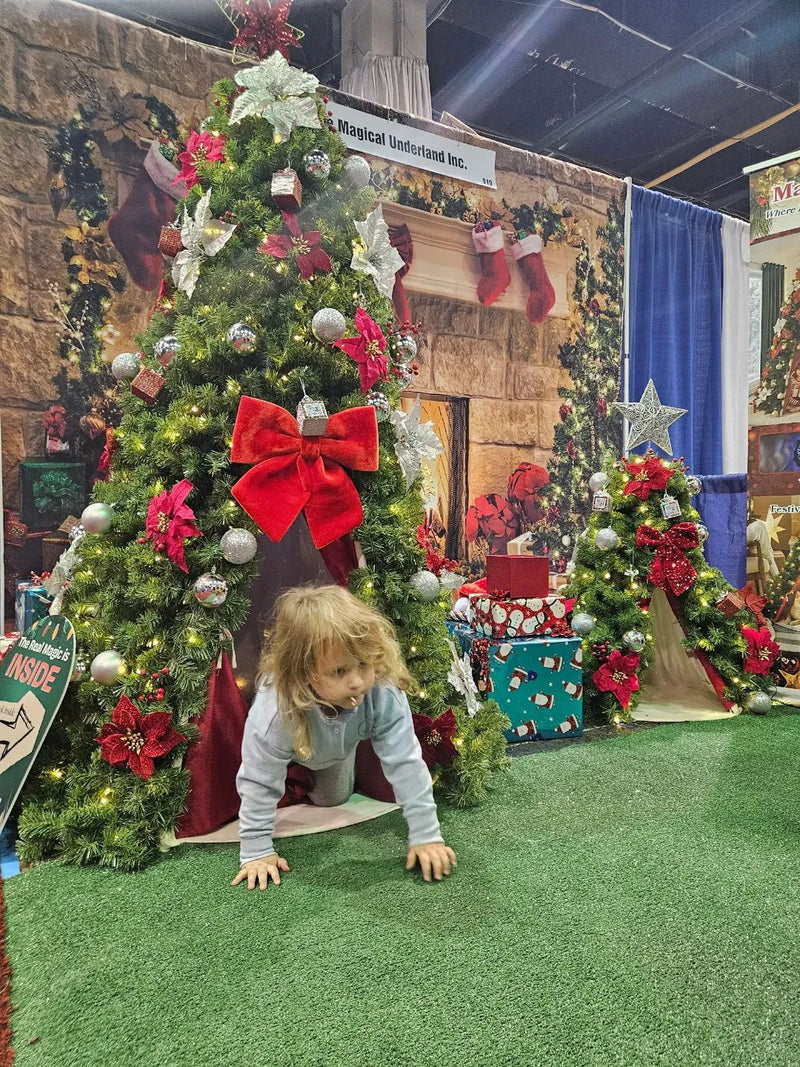 Child crawling out of the Magical Underland® Christmas Tree Tent, a 6-foot indoor Christmas play tent for kids.