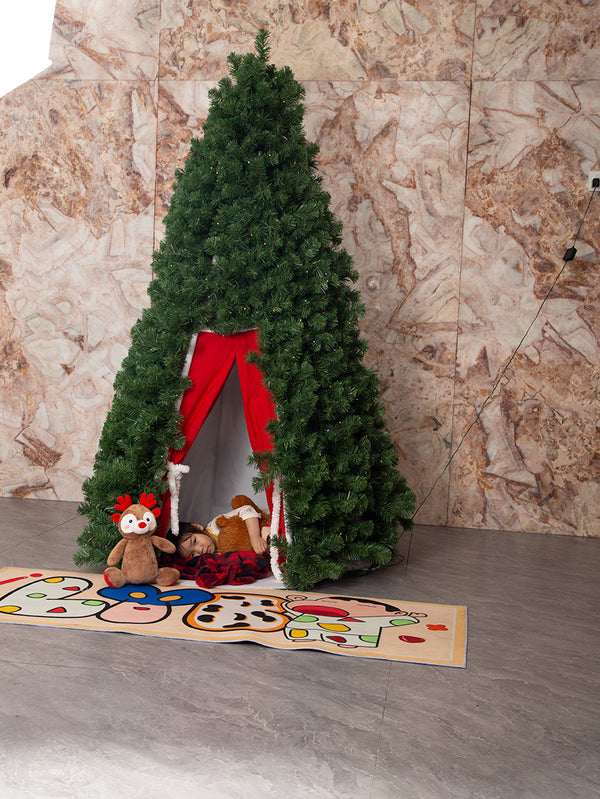 Child sleeping inside the tree on Christmas morning